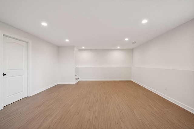 basement with light hardwood / wood-style floors