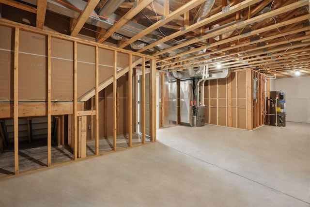 basement featuring heating unit and heat pump water heater