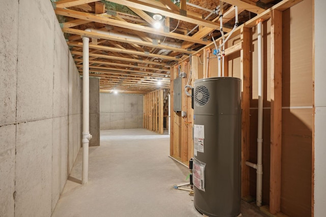 basement featuring electric panel and water heater