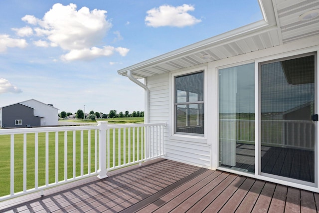 wooden terrace featuring a lawn