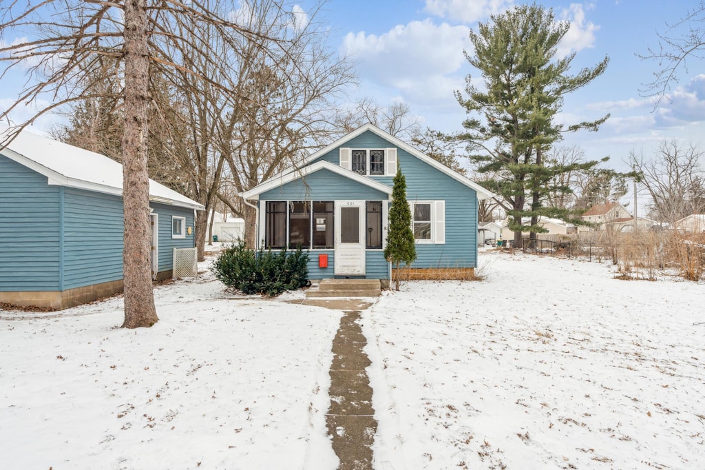 bungalow-style home with a sunroom