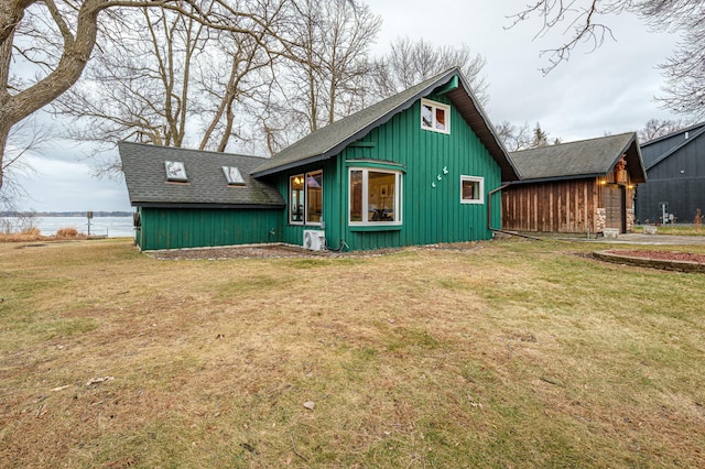 exterior space featuring a lawn and a water view