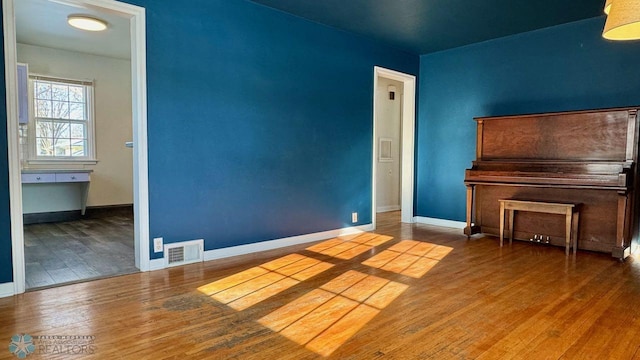 empty room with hardwood / wood-style flooring