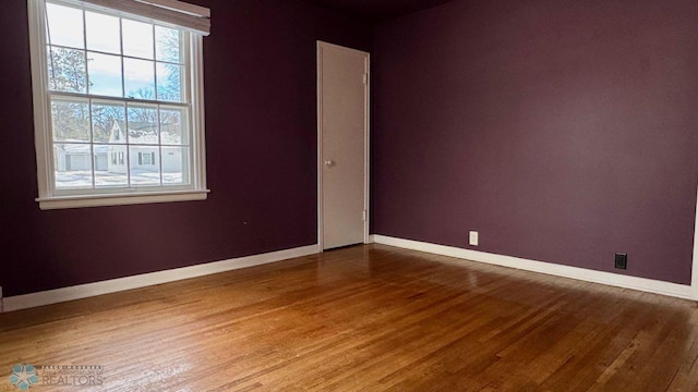 spare room with wood-type flooring