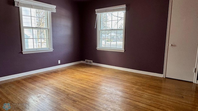 spare room featuring hardwood / wood-style floors