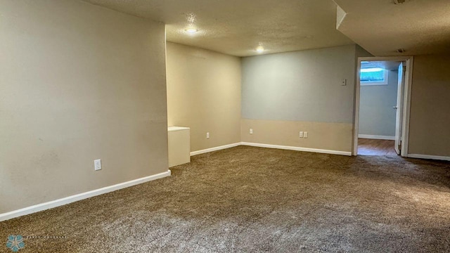 spare room with carpet and a textured ceiling