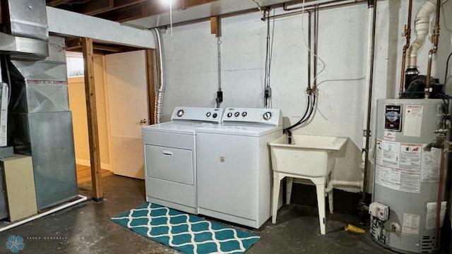 laundry area with gas water heater and washing machine and dryer