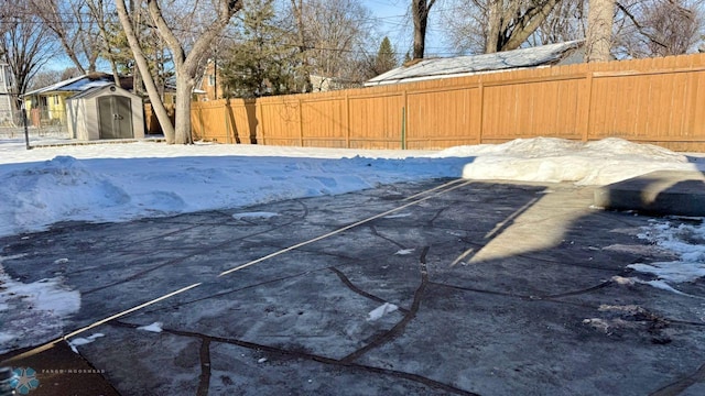 snow covered pool with a storage unit