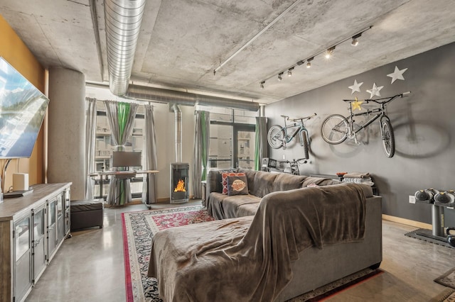 living room featuring concrete flooring and a healthy amount of sunlight