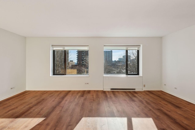 spare room featuring hardwood / wood-style floors