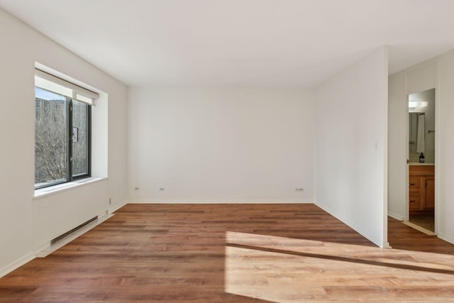 unfurnished room with wood-type flooring