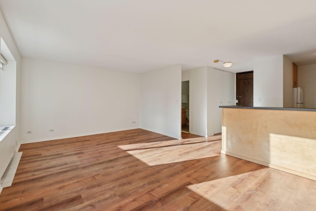 spare room featuring wood-type flooring