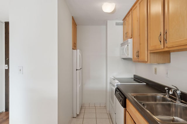 kitchen featuring sink, white appliances, and light tile patterned floors