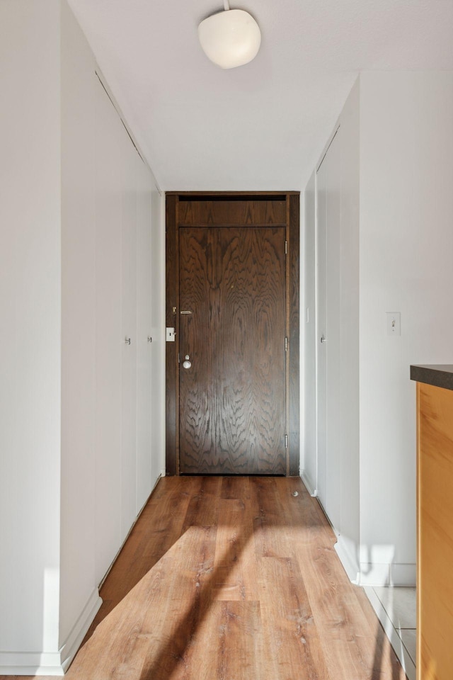 hallway with wood-type flooring