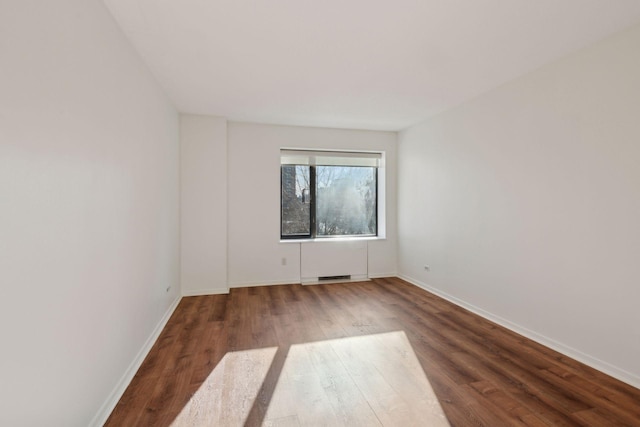 unfurnished room with hardwood / wood-style floors