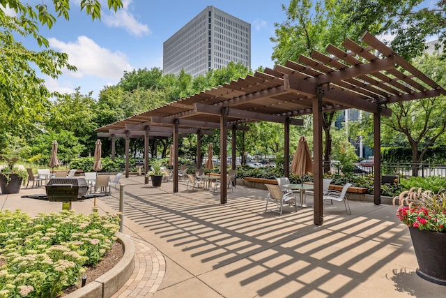 view of property's community with a pergola and a patio area