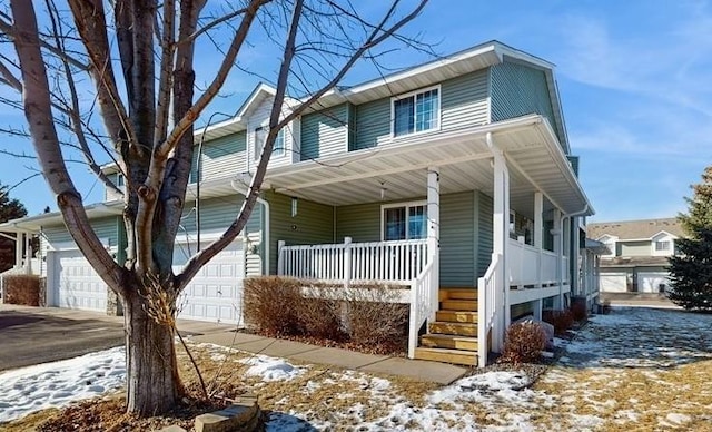 view of front facade featuring a garage, a porch, and driveway