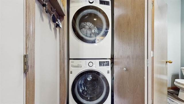 laundry area with laundry area and stacked washer and clothes dryer