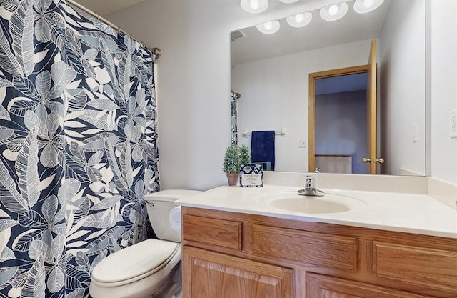 bathroom featuring visible vents, toilet, and vanity