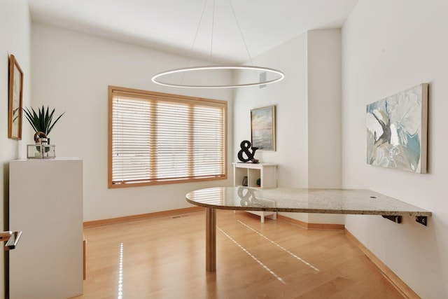 home office featuring light wood-type flooring and baseboards