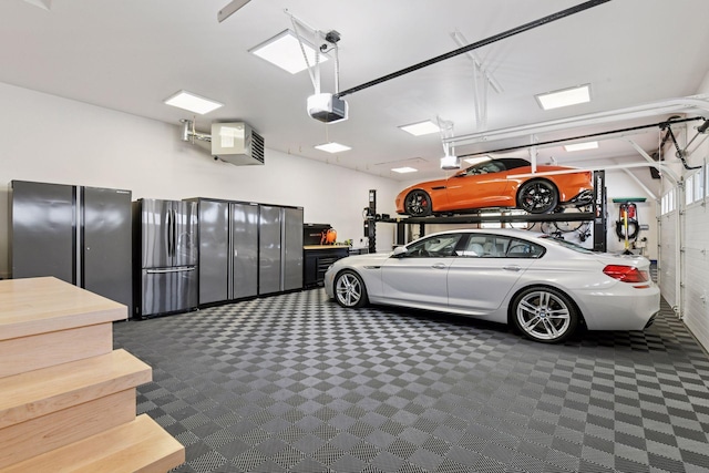 garage featuring a garage door opener and freestanding refrigerator