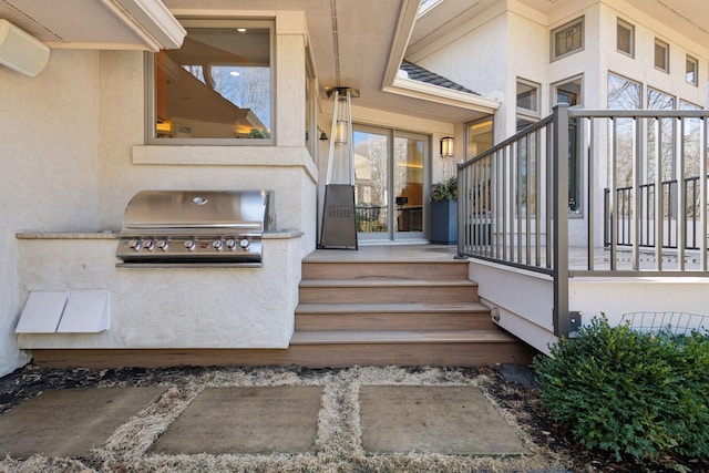 property entrance with exterior kitchen and stucco siding