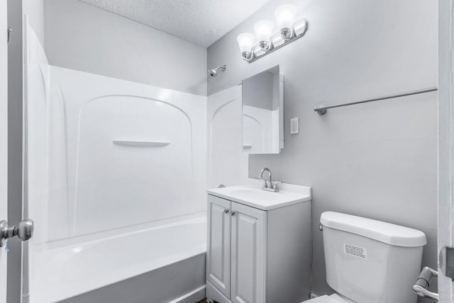 full bathroom with vanity, bathtub / shower combination, toilet, and a textured ceiling