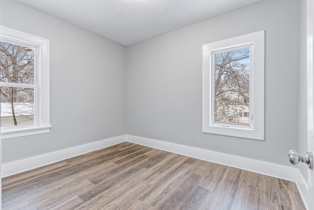 empty room featuring hardwood / wood-style floors and a textured ceiling