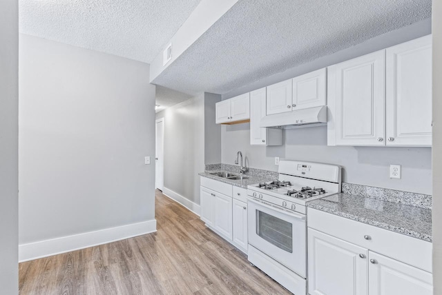 kitchen featuring sink, light hardwood / wood-style floors, a textured ceiling, white cabinets, and white range with gas cooktop