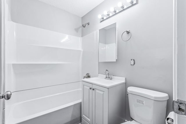 full bathroom featuring vanity, toilet, shower / bathing tub combination, and a textured ceiling