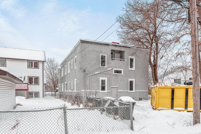 view of snow covered back of property