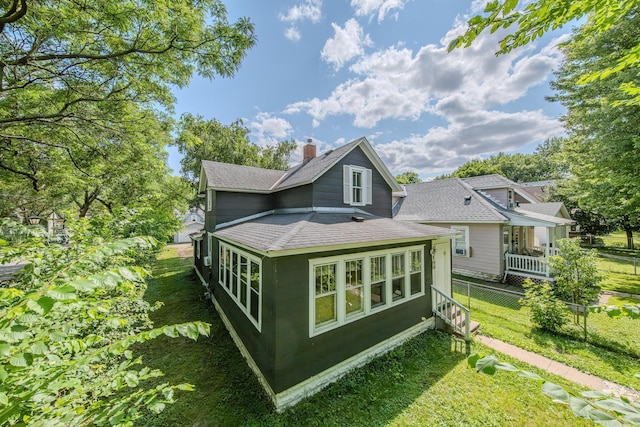 rear view of property with a lawn