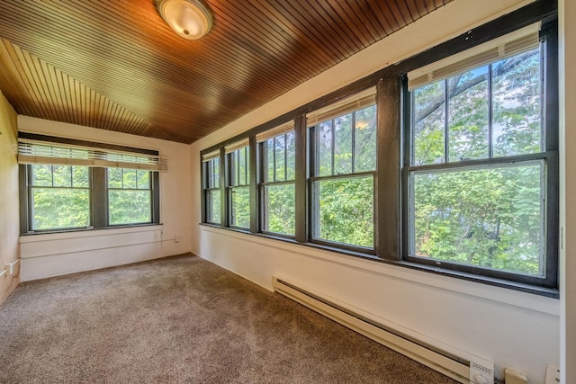 unfurnished sunroom with a baseboard radiator, a healthy amount of sunlight, and lofted ceiling