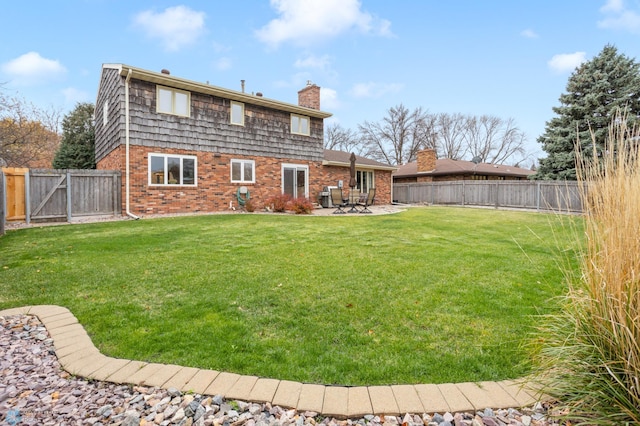 back of house featuring a yard and a patio