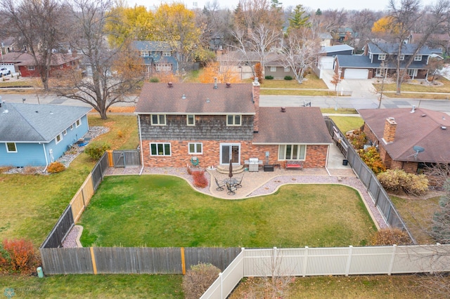 rear view of house featuring a yard and a patio area