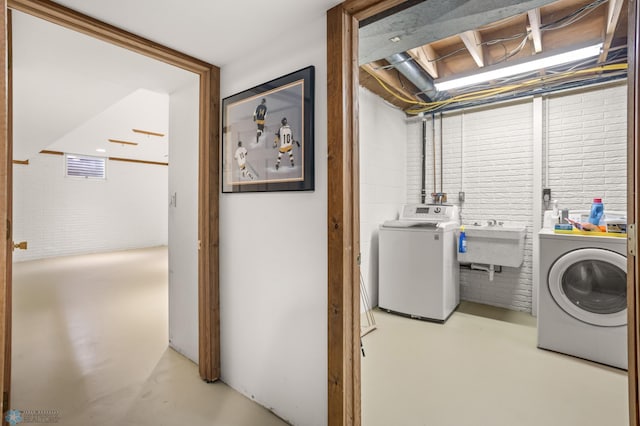 washroom with sink and washing machine and dryer