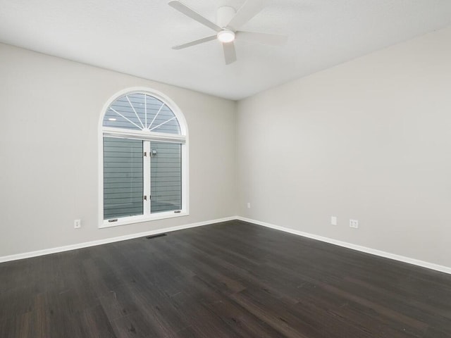 empty room featuring ceiling fan and dark hardwood / wood-style floors