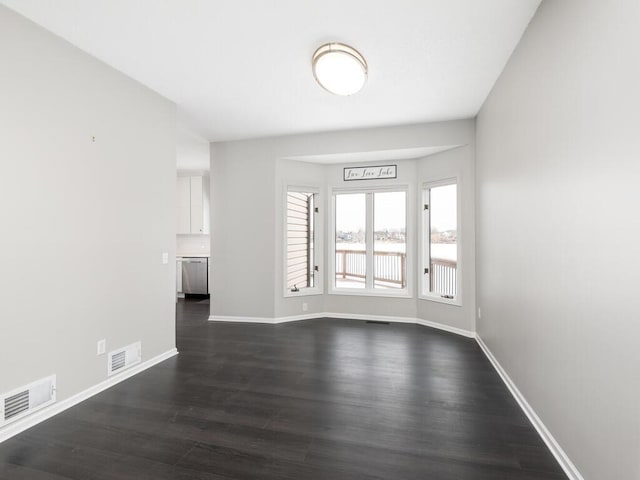 unfurnished room featuring dark wood-type flooring