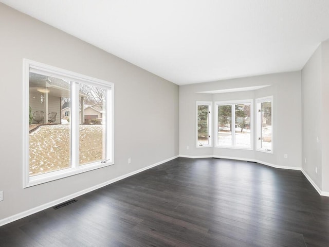 spare room featuring dark hardwood / wood-style flooring