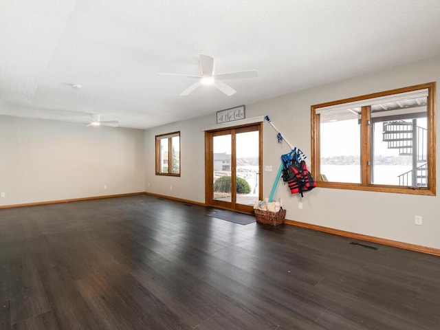 unfurnished room with ceiling fan and dark hardwood / wood-style floors