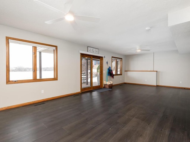 empty room with dark hardwood / wood-style floors and ceiling fan