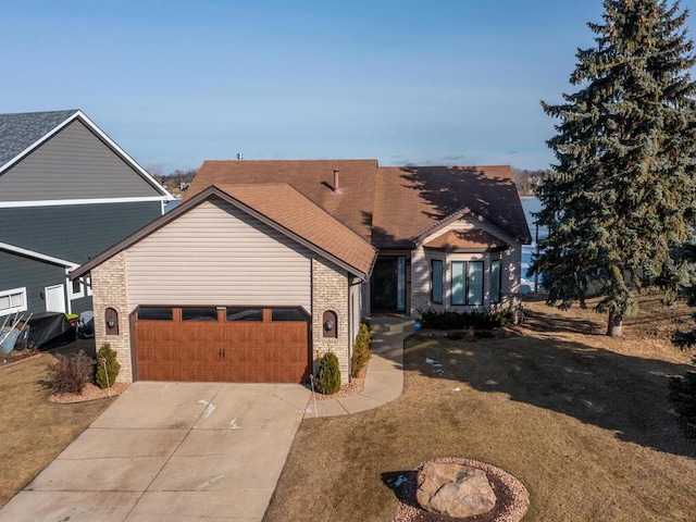 view of front of home with a garage and a front lawn