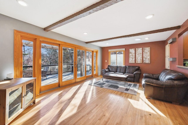 living room with light hardwood / wood-style floors, french doors, and beamed ceiling