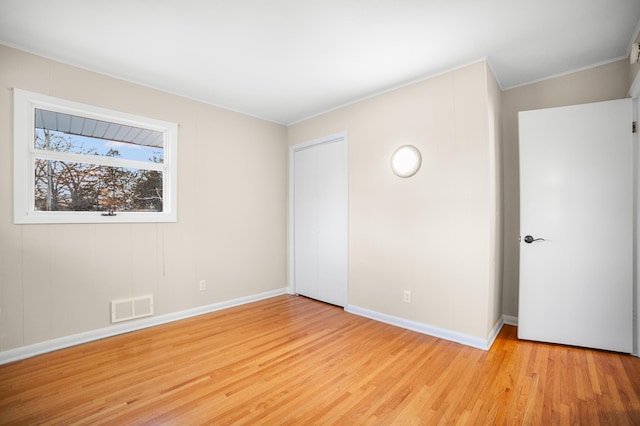 unfurnished room with light wood-type flooring