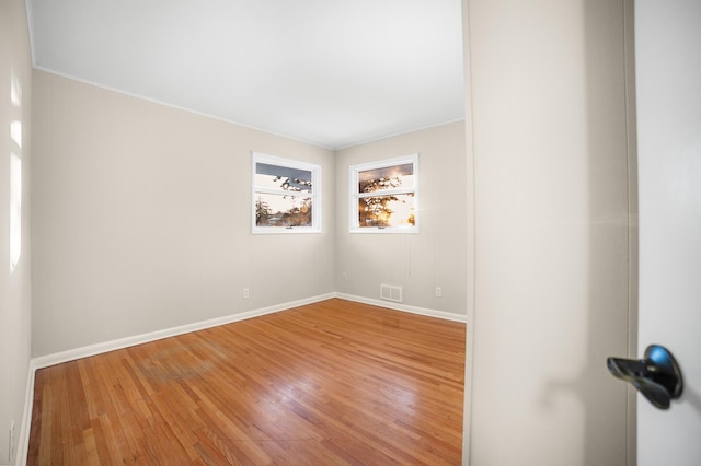 empty room with hardwood / wood-style floors