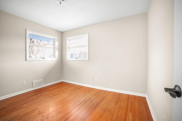 unfurnished room with hardwood / wood-style floors