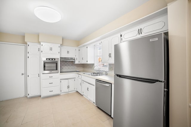 kitchen with white cabinetry, stainless steel appliances, sink, and backsplash