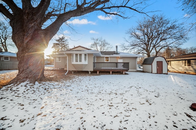 view of front of property with a shed and a wooden deck