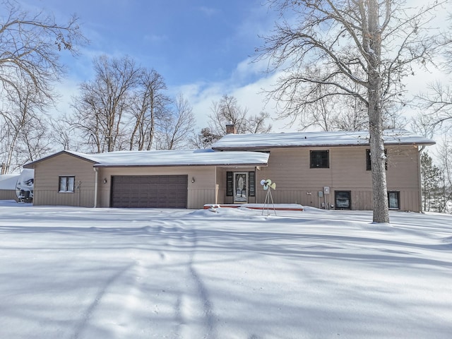 view of front of house with a garage and a chimney