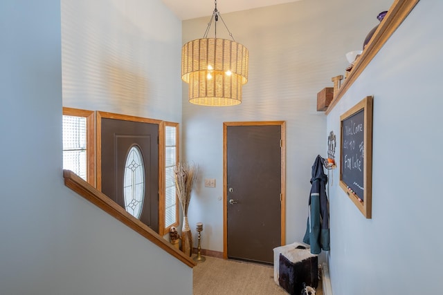 foyer entrance with light carpet, stairway, and baseboards